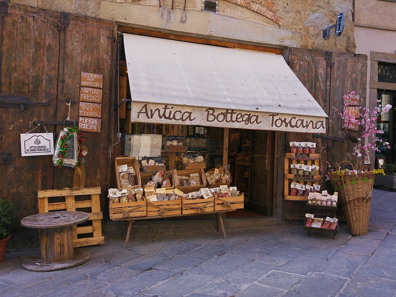 Shopfront with food displayed outside. Awning reads 'Antica Bottega Toscana' 