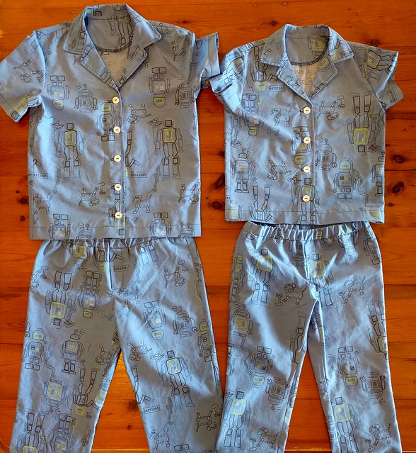 Two pairs of children's pyjamas in robot print.