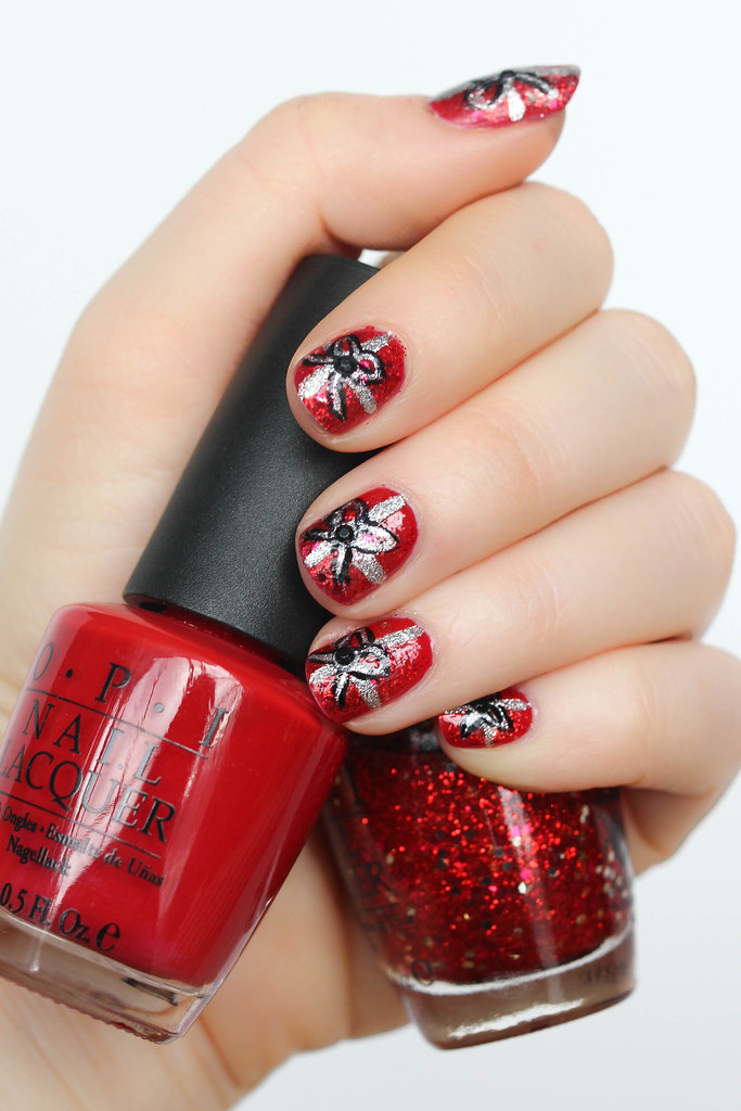 hand with Red Glitter Christmas Bow Nails