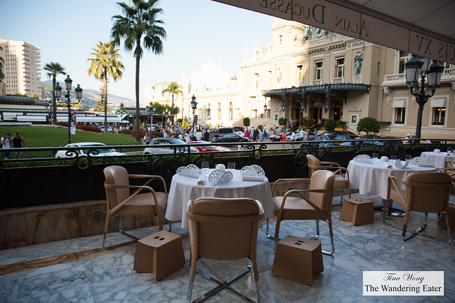 Outdoor seating area with a view of the very expensive and rare cars