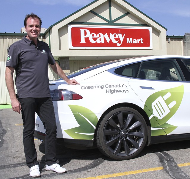 Kent Rathwell of Sun Country Highway with his Tesla Model S at Peavey Mart Red Deer, Alberta. This family sedan can go 0-100 in 3.9 seconds!