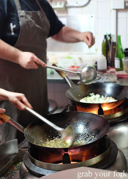 Mike Eggert and Jemma Whiteman on the woks in the kitchen at Good Luck Pinbone in Kingsford
