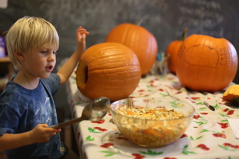 scooping out his pumpkin