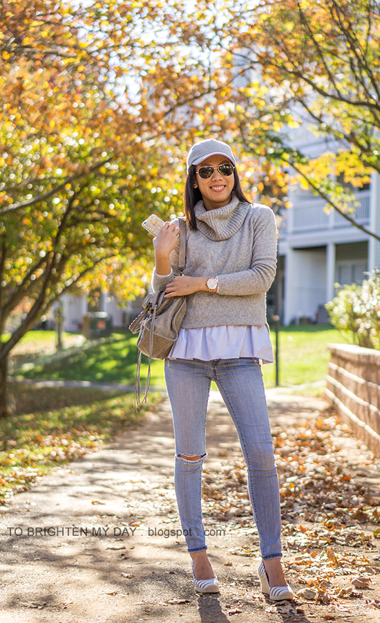 gray baseball cap, gray cowlneck sweater layered over baby blue peplum top, oversized watch, distressed lightwash skinny jeans, gray tote, striped espadrille wedges