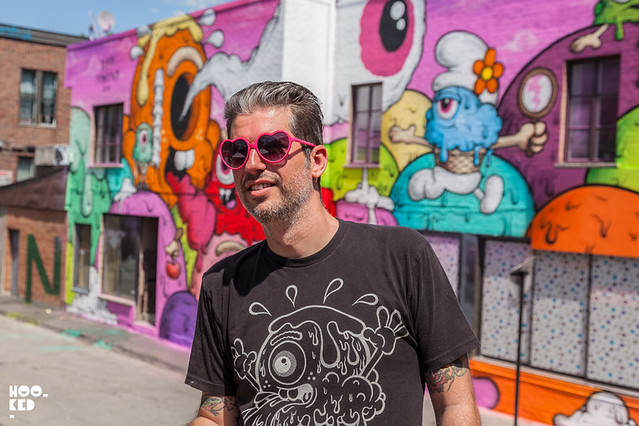 Artist Buff Monster portrait in front of his Seven Deadly Sins wall for Mural Festival