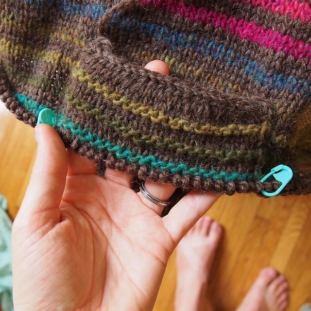 I'm doing garter ridges just over the pocket for each Noro stripe because I think the contrast looks awesome.
