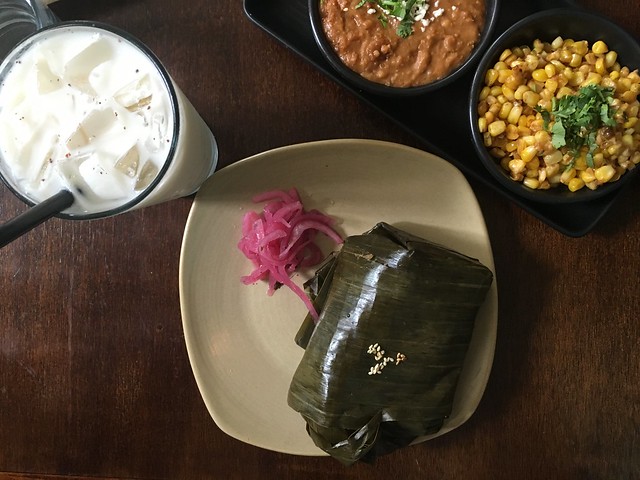 Tamale Boy horchata and tamale with sides of spicy corn and bacon-chorizo beans