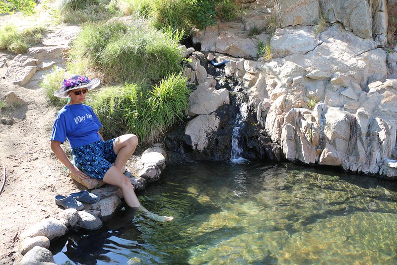 Vicki tests the temperature at Deep Creek Hot Springs - it was HOT