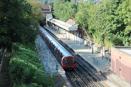 Rear Portion 91165 waits to depart from Chigwell Station for Woodford